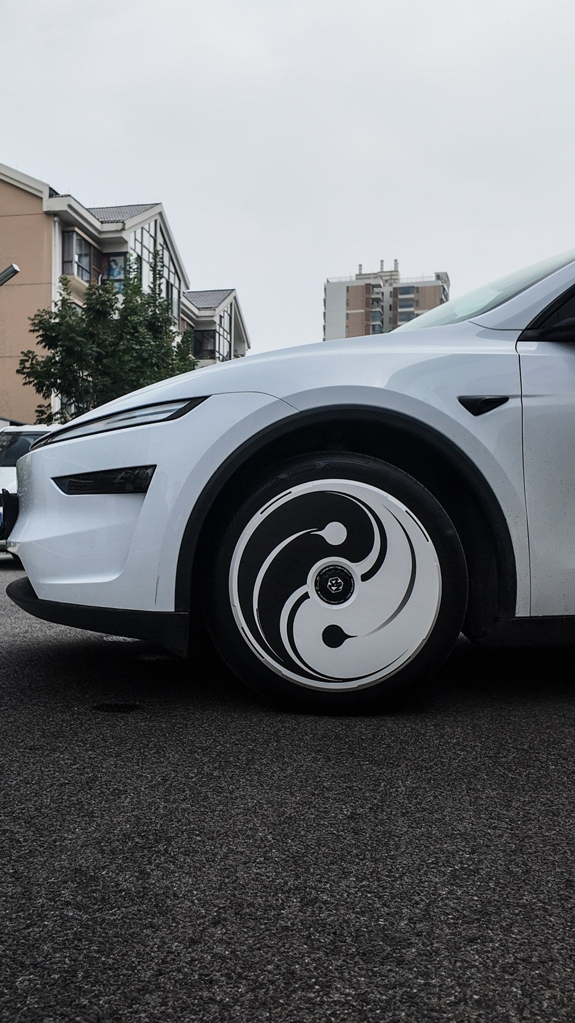 Yin Yang cover fitted on a Tesla Model Y front wheel