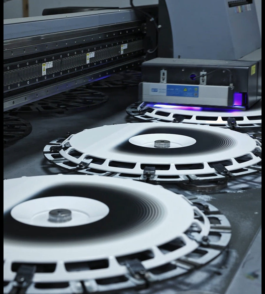 Freshly UV-cured wheel cover faces on the print bed