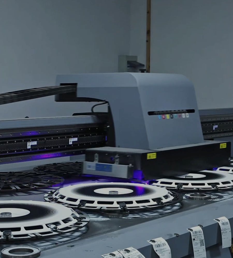 Wheel covers being UV printed on the flatbed bed