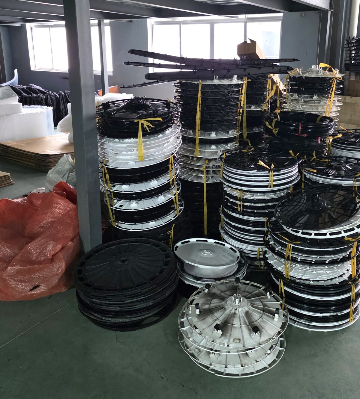 Stacks of wheel cover blanks held in stock