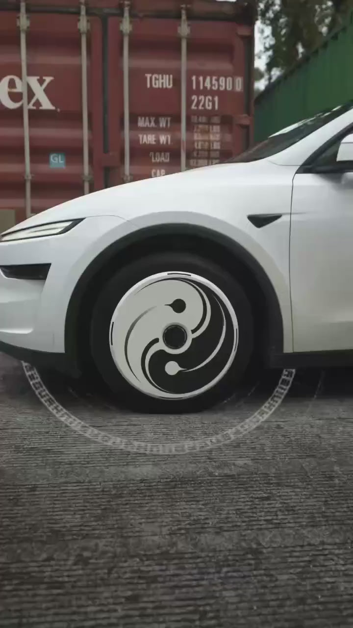 Yin Yang aero wheel covers in motion on a Tesla Model Y